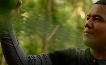 Foraging experience at Amanera resort, guest holding fresh green produce amongst trees