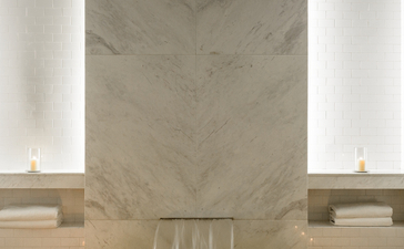 Spa plunge pool at Amangalla with marble walls and candlelit sides.