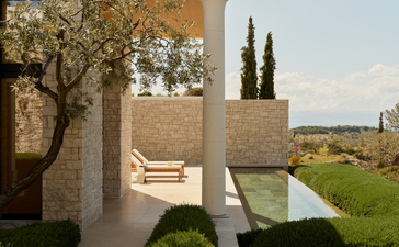 Deluxe pool pavilion with plunge pool at Amanzoe resort, featuring stone columns and countryside views.