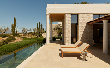 Deluxe pool pavilion with terrace overlooking gardens at Amanzoe resort, Greece.