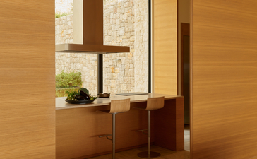 Villa 22 entrance with wooden doors and stone cross detail at Amanzoe resort.