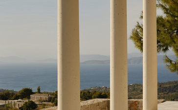 Villa terrace with stone columns overlooking the Aegean Sea at Amanzoe.