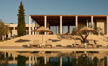 Villa with colonnade overlooking waterfront at Amanzoe, Greece.