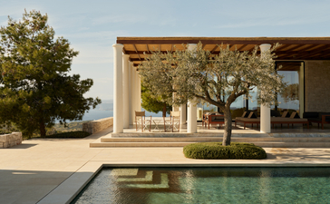 Villa with reflecting pool and mature trees at Amanzoe, Greece.