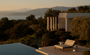 Villa terrace with loungers overlooking Aegean Sea at Amanzoe, Greece.