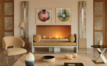 Villa lounge at Amanzoe with fireplace, seating areas and contemporary artwork.