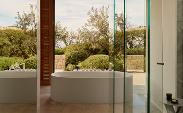Villa interior with plunge pool overlooking olive groves at Amanzoe, Greece.