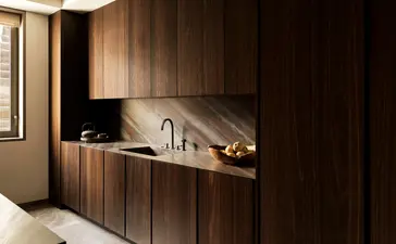 Cuisine aux teintes chaudes d'une résidence trois chambres à Aman New York.