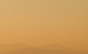 Golden sunset over Aegean islands at Amanzoe, Greece.