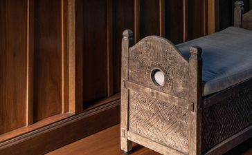 Carved stone architectural detail beside bed in Duplex Suite at Amandari, Ubud, Bali.