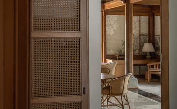 Village Suite at Amandari with wooden sliding door opening to bedroom and en-suite bathroom in Ubud, Bali.