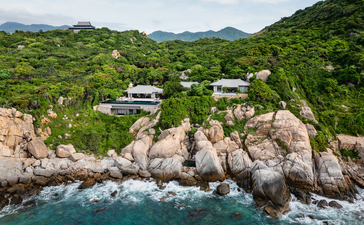 Aerial view of a three-bedroom ocean pool residence at Amanoi in Vietnam, nestled among rocky cliffs and coastal landscape.