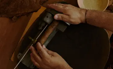Hands demonstrating cigar rolling techniques during a class at Amanera, Dominican Republic.