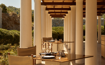 Amanzoe beach club restaurant with a covered dining terrace overlooking the Aegean Sea.