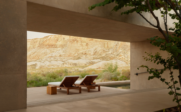 Girijaala suite with view of desert landscape and two loungers at Amangiri resort.