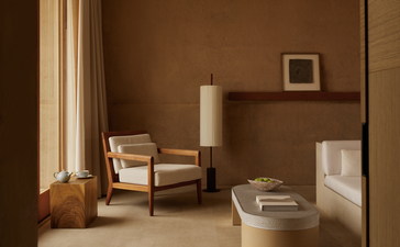 Desert suite at Amangiri with warm earth tones, minimalist furnishings, and natural light from floor-to-ceiling windows.