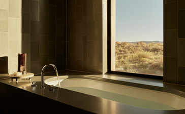Desert suite bathroom at Amangiri with soaking tub and expansive canyon views.