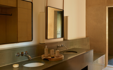 Mesa Suite bathroom at Amangiri resort, featuring warm earth tones, double vanity and modern fixtures.