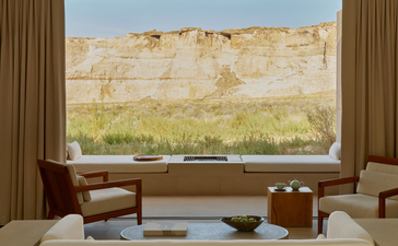 Mesa Suite bedroom with expansive window overlooking desert landscape at Amangiri resort.
