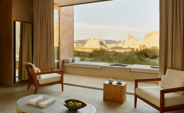 Orchard Suite sitting area at Amangiri with floor-to-ceiling windows framing desert landscape views.