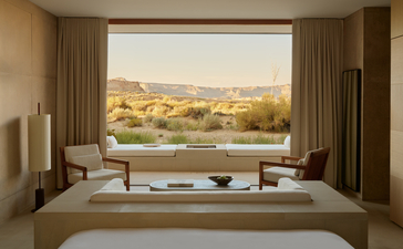 Principal bedroom in the Orchard Suite at Amangiri, with bed facing large window overlooking desert landscape.