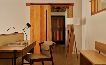 Wooden pavilion interior at Amangiri with desk, chair, and warm earth tones.