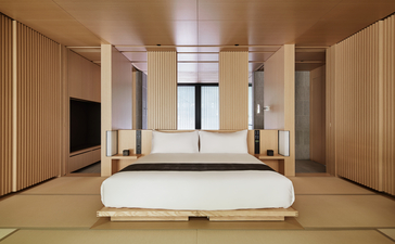 Principal bedroom at Aman Kyoto with tatami flooring, sliding doors, and minimalist furnishings.