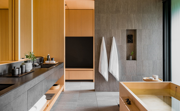 Spa bathroom at Aman Kyoto with wooden accents, soaking tub and minimalist design.