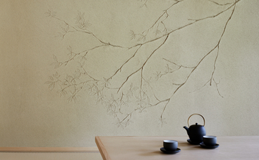 Minimalist table display at Aman Kyoto with delicate branch artwork, ceramic vessel and tea service.