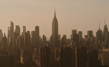 Manhattan skyline with Empire State Building rising above surrounding skyscrapers at Aman New York.