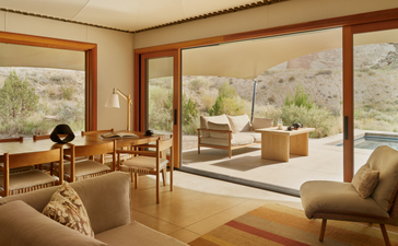Mesa Pavilion living area at Amangiri, with floor-to-ceiling windows overlooking desert landscape and contemporary furnishings.