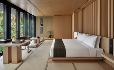 Susuki room at Aman Kyoto with platform bed, wooden screens, and garden views.