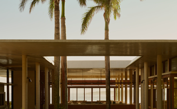 Wooden pavilion with open sides and palm trees at Amanera resort.
