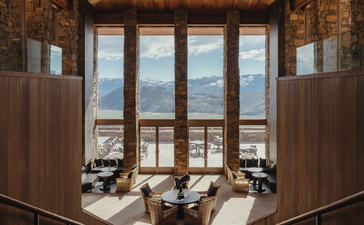 Amangani's lobby features wooden panelling and large windows framing views of Wyoming's landscape.