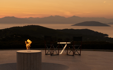 Candlelit table at sunset overlooking the Aegean Sea at Amanzoe.