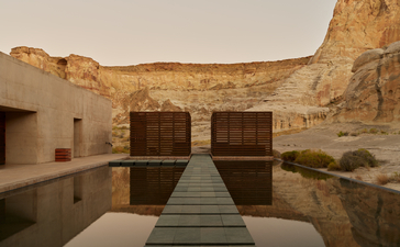 Spa pool at Amangiri with warm stone walls reflected in still water.