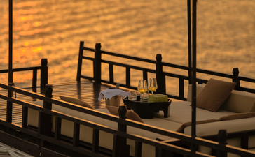 Wooden boat deck at sunset on the Tonlé Sap Lake, Amansara, Cambodia.
