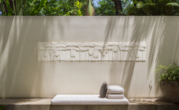 Suite terrace at Amansara with sheer curtains and garden views.