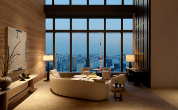 Communal library at Aman Tokyo with curved seating, floor-to-ceiling windows overlooking the city at dusk.