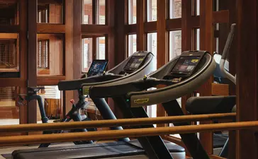 Spa and gym at Amangani with treadmills and wooden interior.
