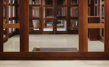 Yoga studio at Amangani with wooden-framed mirrors and a grey mat on pale flooring.