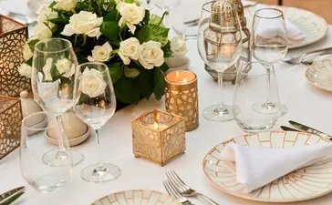 Maison Jardin dining table set with white flowers and place settings at Amanjena resort.