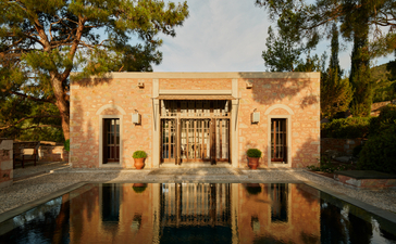 Amanruya garden pavilion reflected in still water at dusk, Turkey.