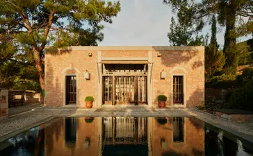Amanruya garden pavilion reflected in still water at dusk, Turkey.