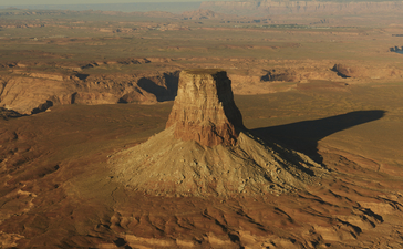 Aerial view of a distinctive rock formation rising from the desert landscape at Amangiri.