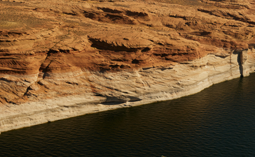 Aerial view of a boat navigating the waters of Lake Powell near Amangiri.