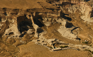 Aerial view of Amangiri's desert landscape with angular rock formations and sandy terrain.
