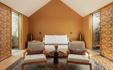 Ming Pavilion lounge at Amanyangyun, Shanghai, with symmetrical seating and warm wooden interiors.