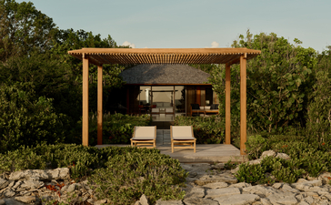 Amanyara pavilion with wooden pergola structure overlooking Turks and Caicos landscape.
