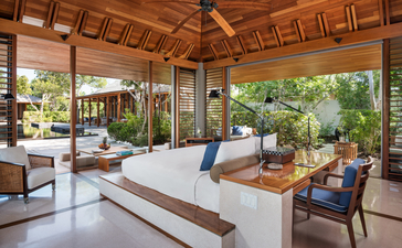 Five-bedroom beach sala villa at Amanyara with wooden ceiling, open-air lounge, and garden views.